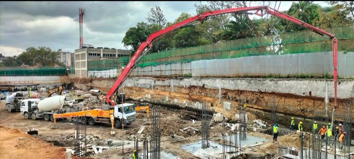 Concrete being prepared and handled with care, illustrating the process from batching to placement.