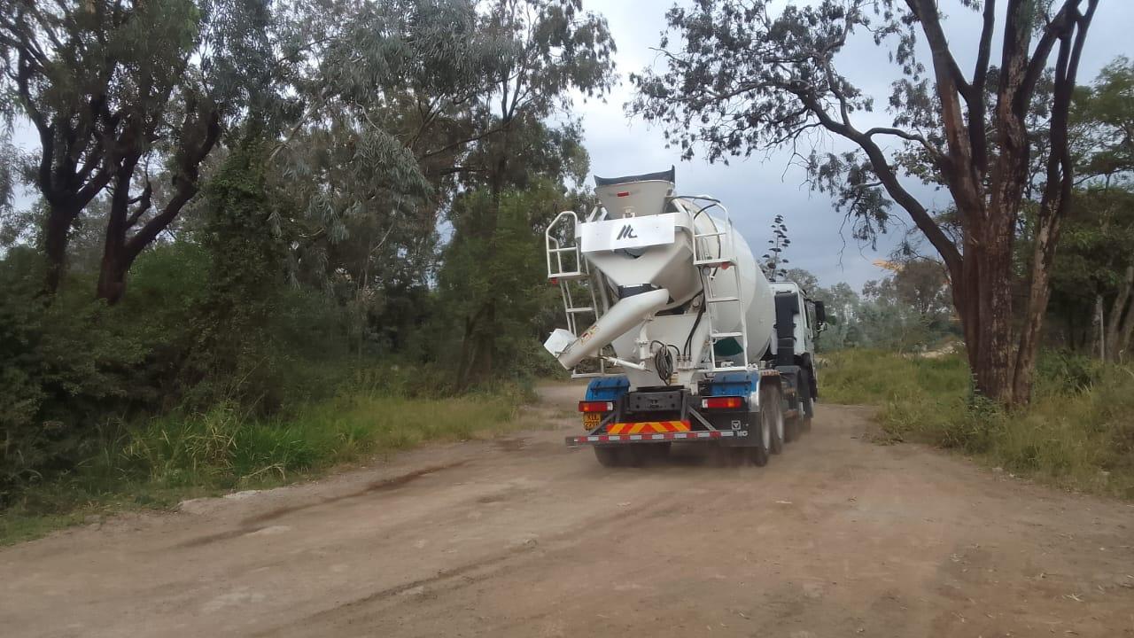 Images capturing the process of concrete pouring and site preparation for various projects.