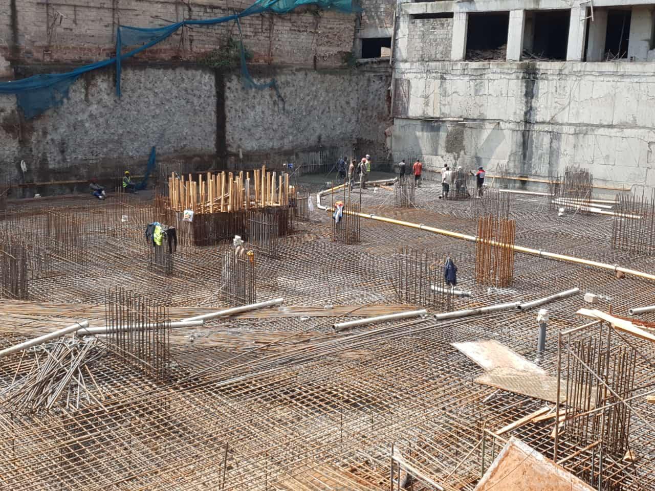 Images capturing the process of concrete pouring and site preparation for various projects.
