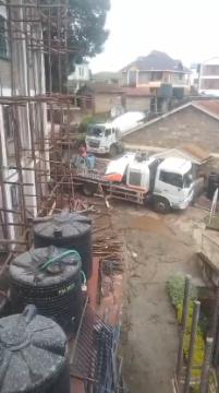 Our ready-mix concrete being transported and applied, demonstrating efficient construction practices.