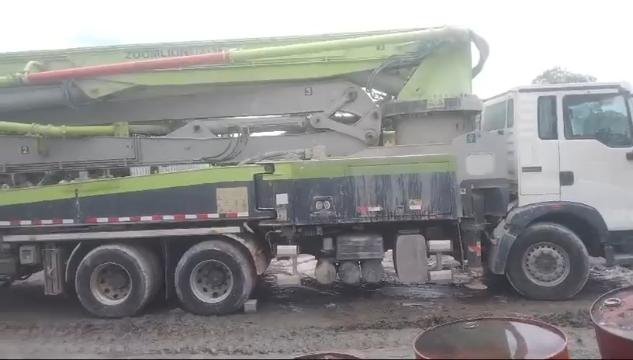 Images capturing the process of concrete pouring and site preparation for various projects.